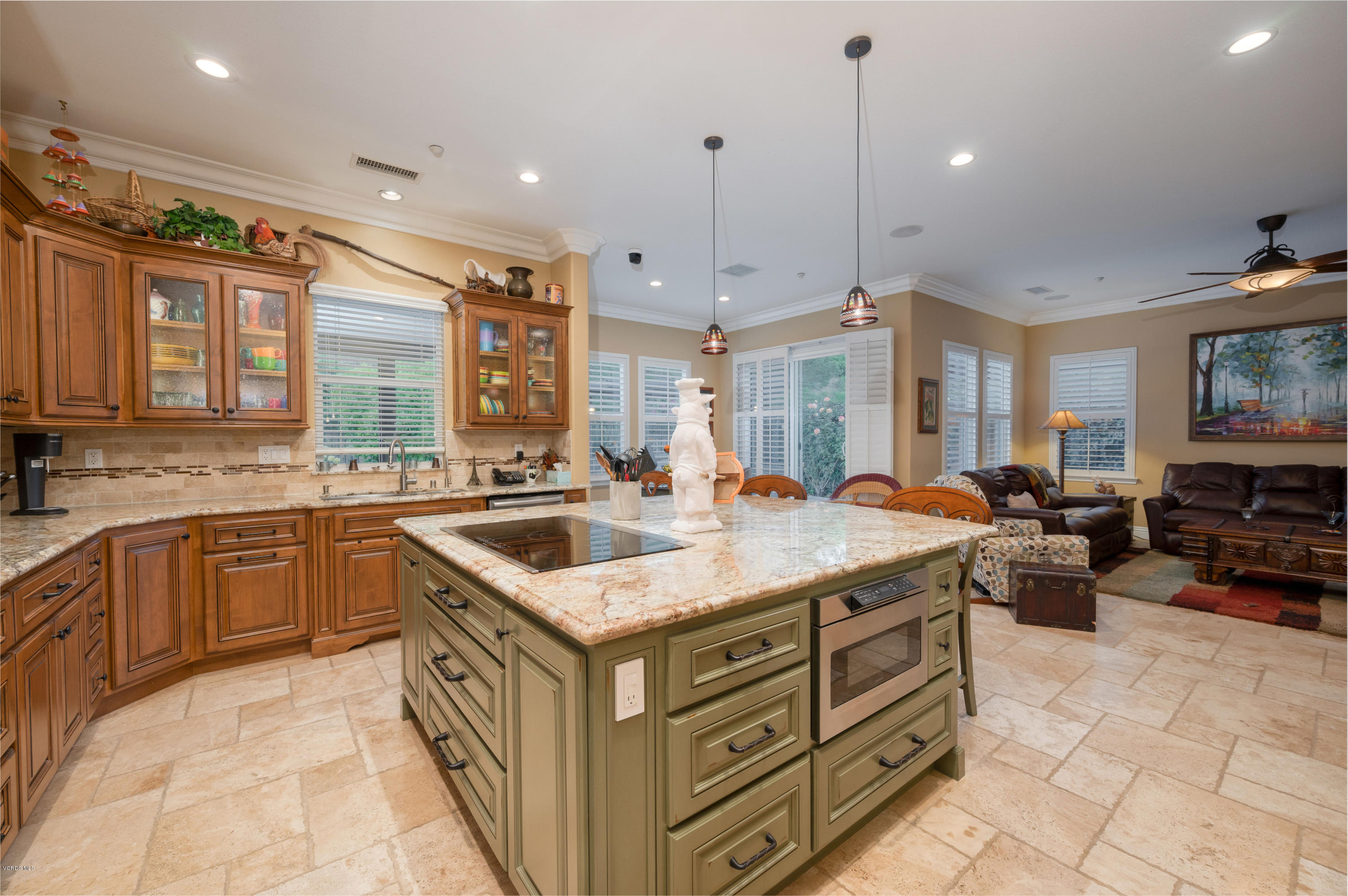 6945 Shadow Wood Drive Moorpark, CA 93021 - Photo 15 of 42 a kitchen with a stove a sink a counter top space and living room view