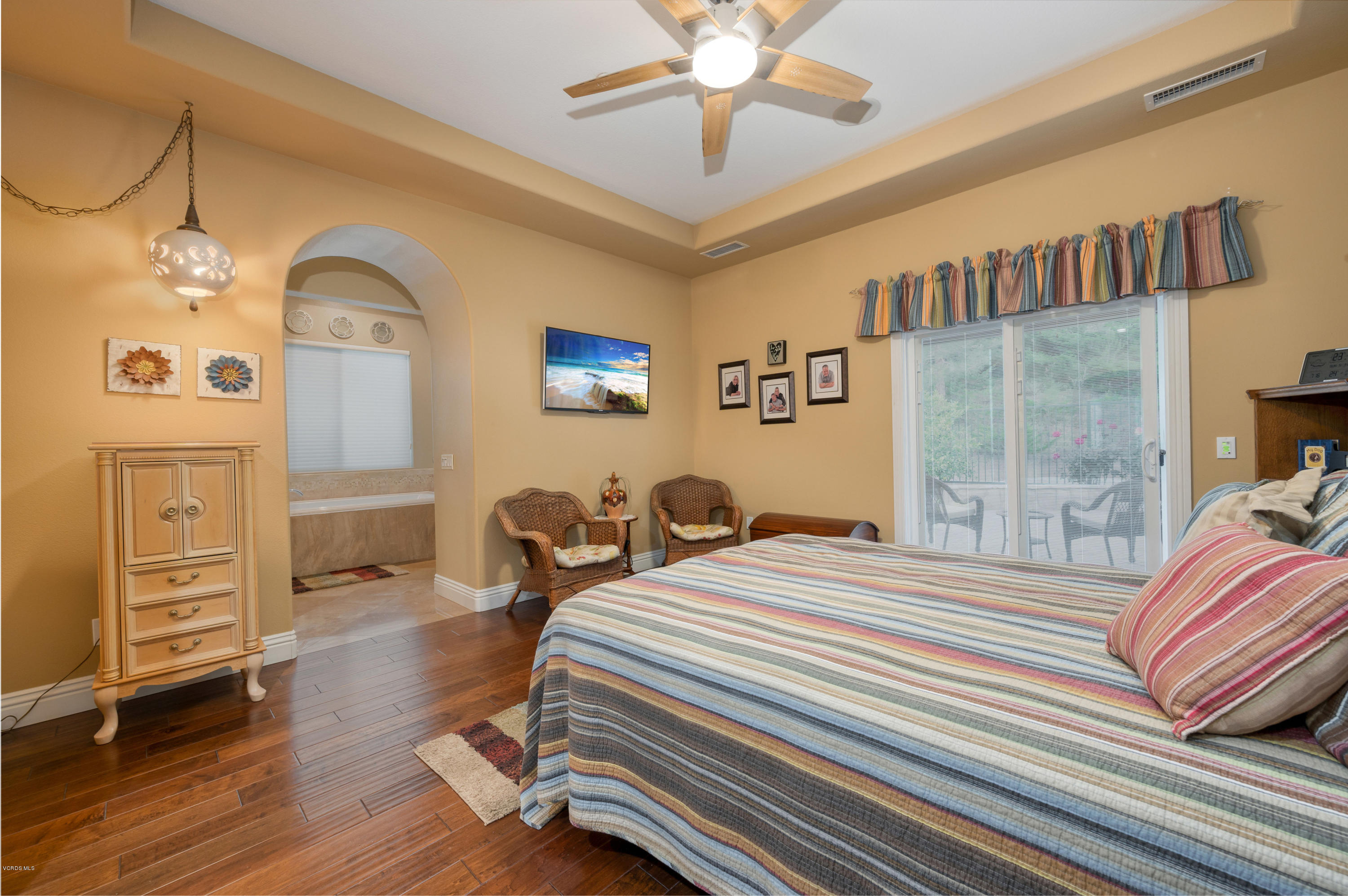 6945 Shadow Wood Drive Moorpark, CA 93021 - Photo 23 of 42 a bedroom with a bed and wooden floor
