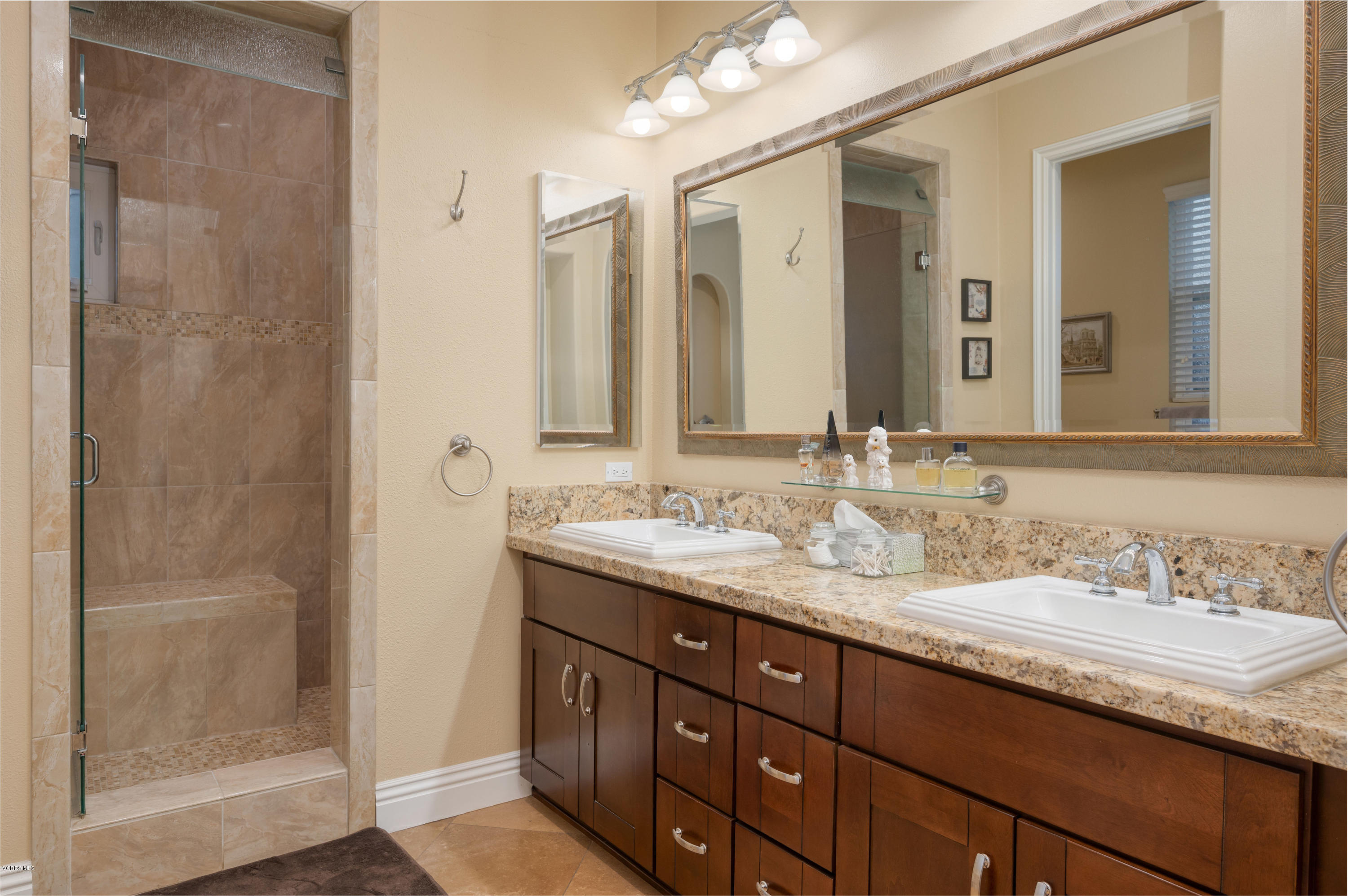 6945 Shadow Wood Drive Moorpark, CA 93021 - Photo 27 of 42 a bathroom with a granite countertop sink and a mirror