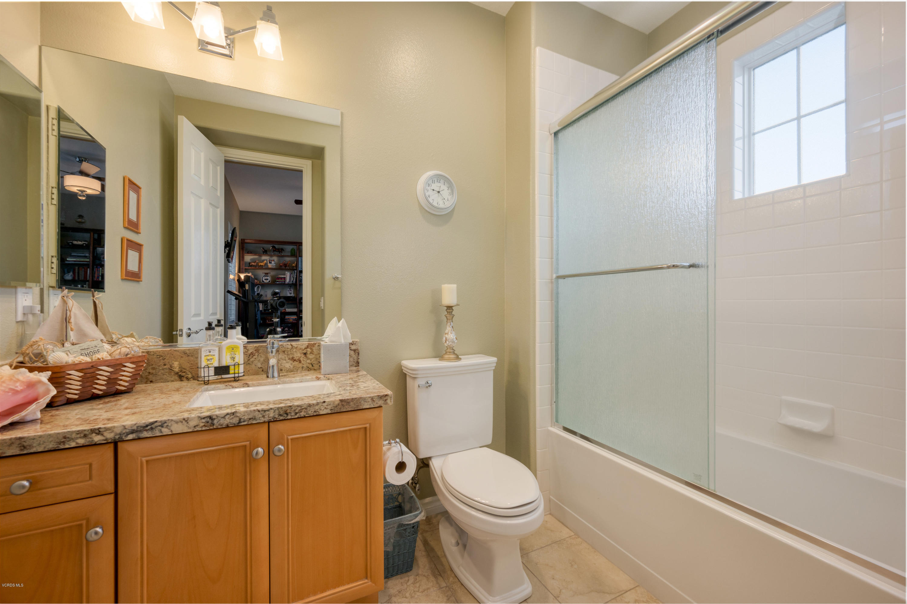 6945 Shadow Wood Drive Moorpark, CA 93021 - Photo 34 of 42 a bathroom with a granite countertop sink toilet and shower