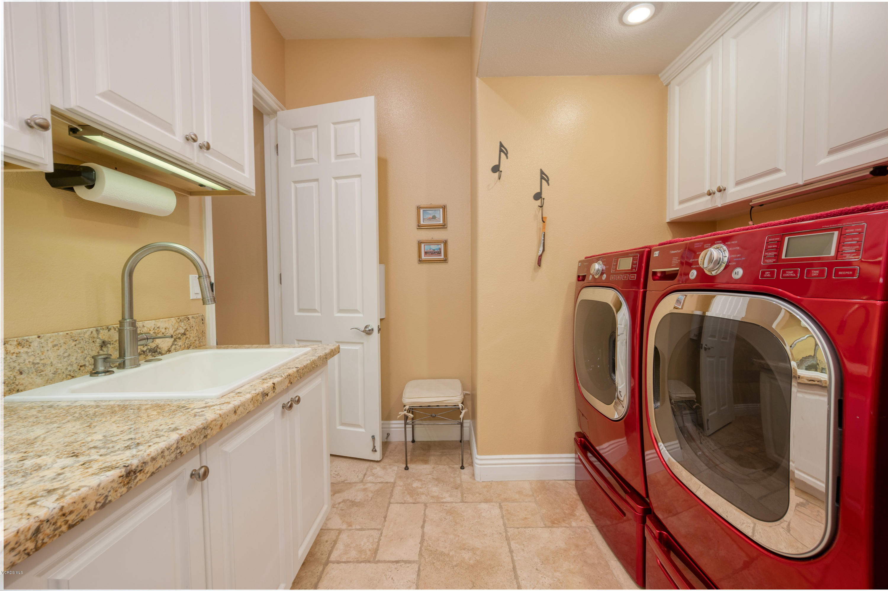 6945 Shadow Wood Drive Moorpark, CA 93021 - Photo 36 of 42 a spacious bathroom with a granite countertop sink and a mirror