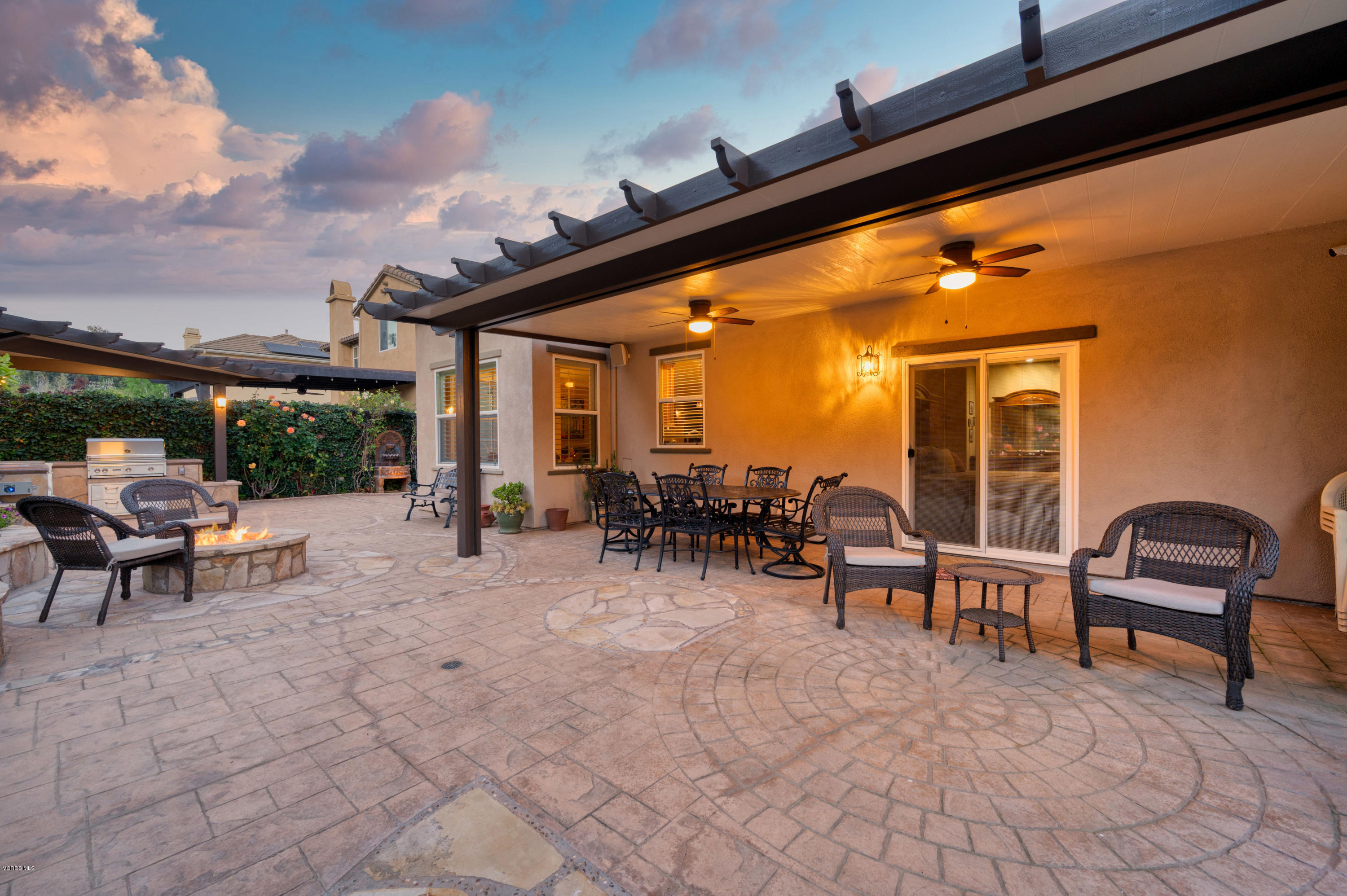 6945 Shadow Wood Drive Moorpark, CA 93021 - Photo 42 of 42 a view of a patio with table and chairs and potted plants