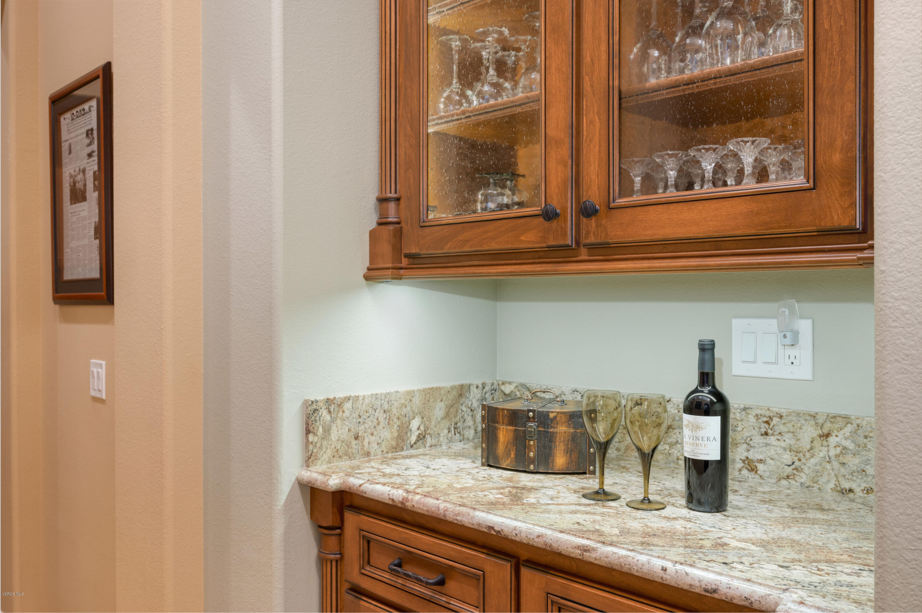 6945 Shadow Wood Drive Moorpark, CA 93021 - Photo 8 of 42 a kitchen with a granite countertop sink and cabinets