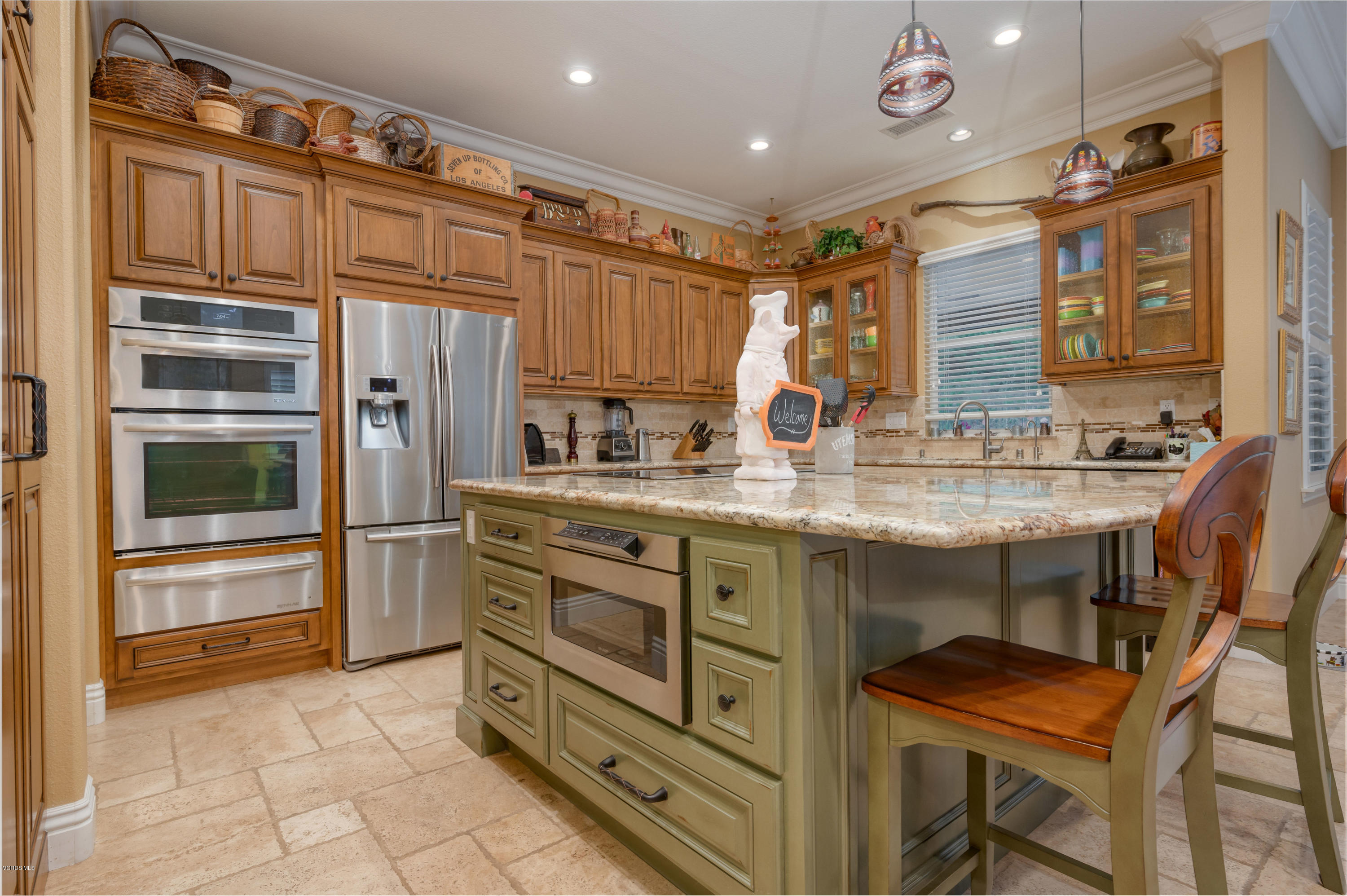 6945 Shadow Wood Drive Moorpark, CA 93021 - Photo 9 of 42 a kitchen with stainless steel appliances granite countertop a stove and cabinets
