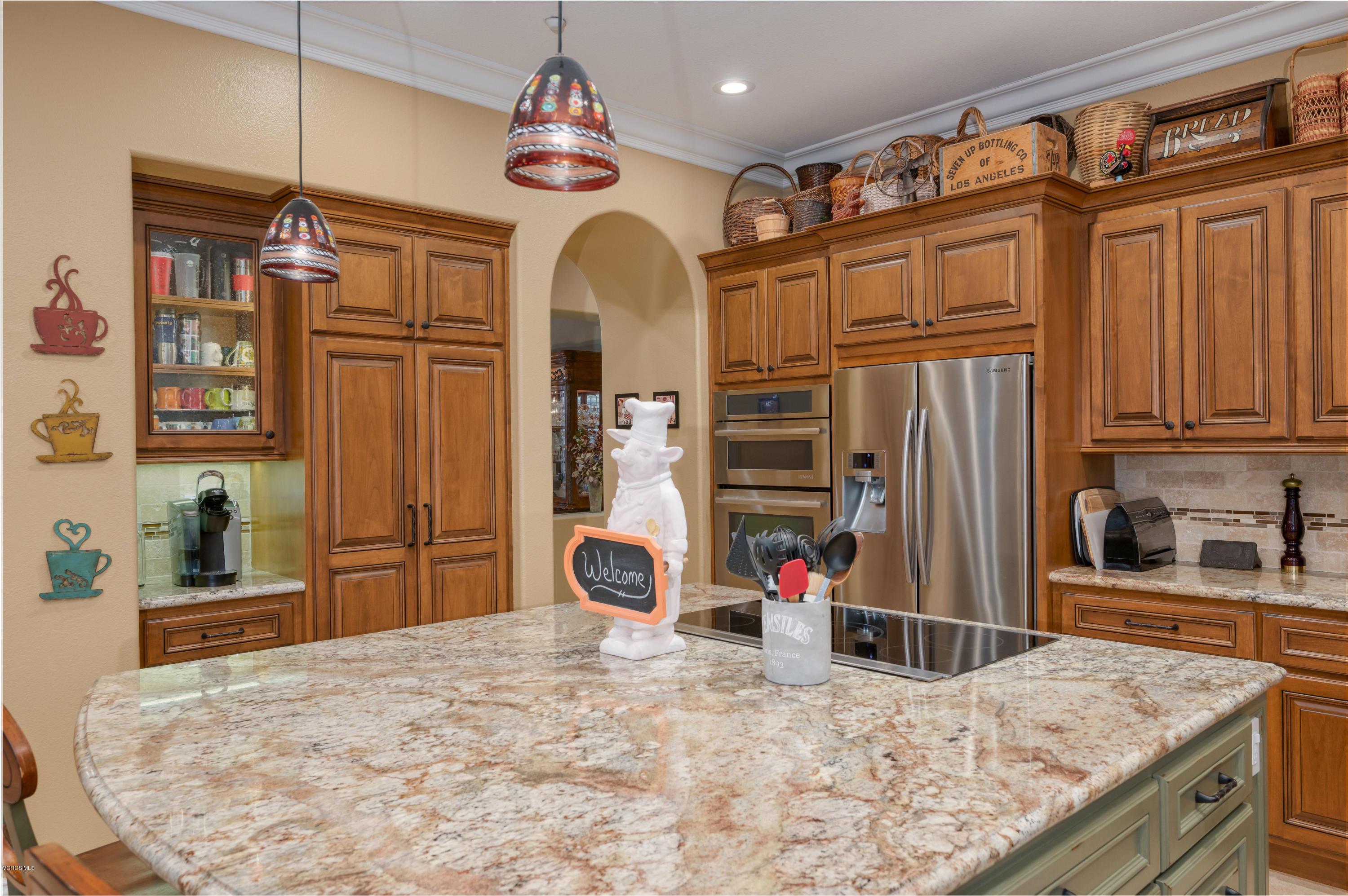 6945 Shadow Wood Drive Moorpark, CA 93021 - Photo 10 of 42 a kitchen with sink refrigerator and stove