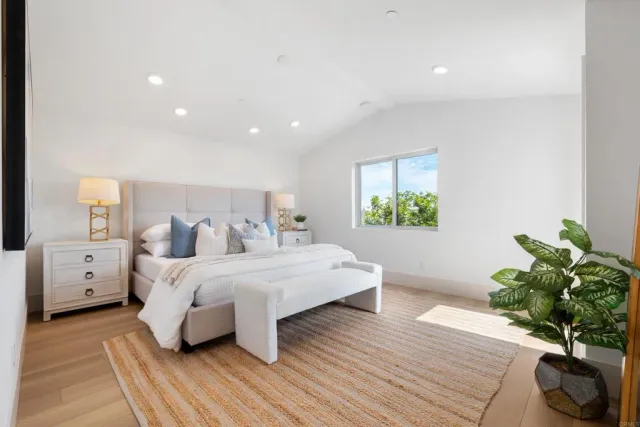 a bedroom with a bed and a large window