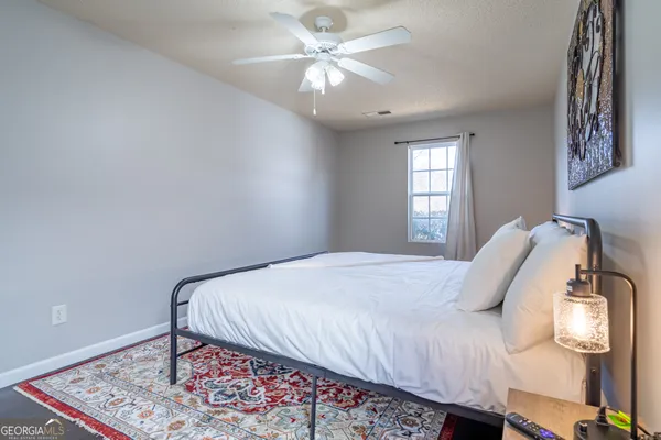 a bedroom with a bed and a window