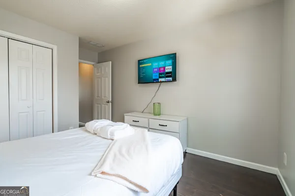 a bedroom with a bed and a flat screen tv