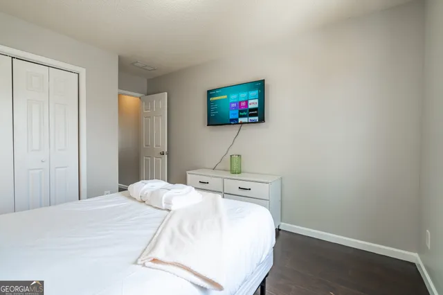 a bedroom with a bed and a flat screen tv