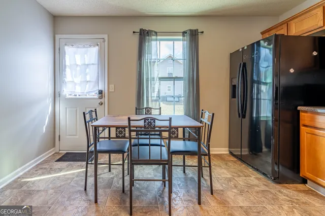 a view of a dining room with furniture and a window