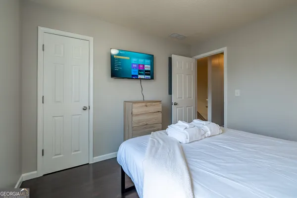 a bedroom with a bed and a flat screen tv