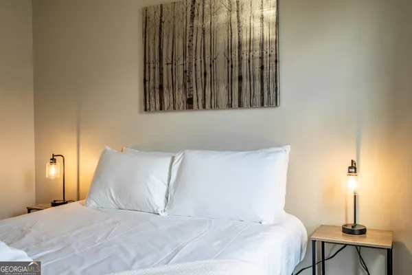 a bedroom with a bed and a lamp