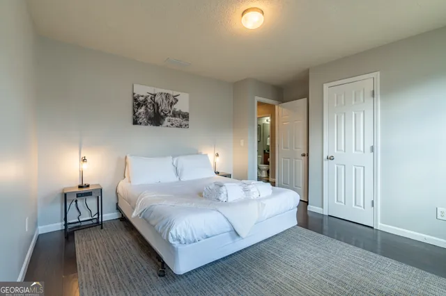 a bedroom with a bed and a night stand