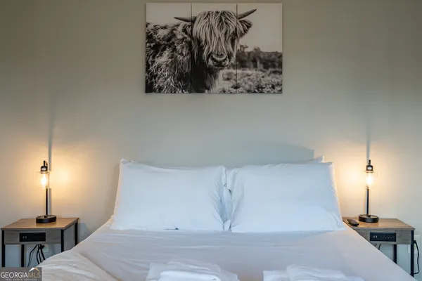 a room with a bed and a night stand