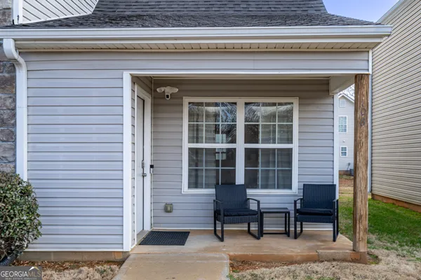a view of a wooden bench sitting in front of a house
