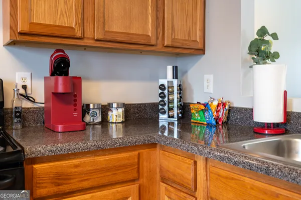 a kitchen with granite countertop a sink and cabinets