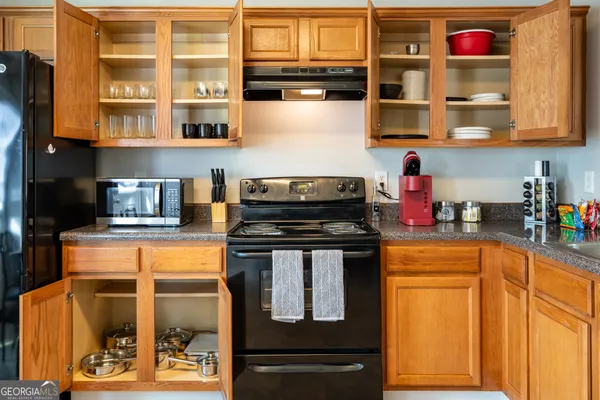 a kitchen with stainless steel appliances granite countertop a stove and cabinets