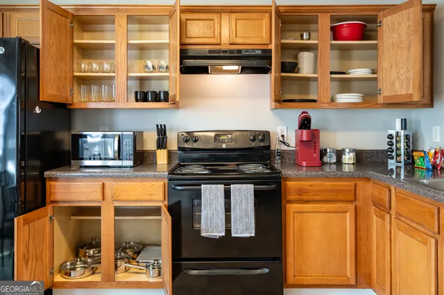 a kitchen with stainless steel appliances granite countertop a stove and cabinets