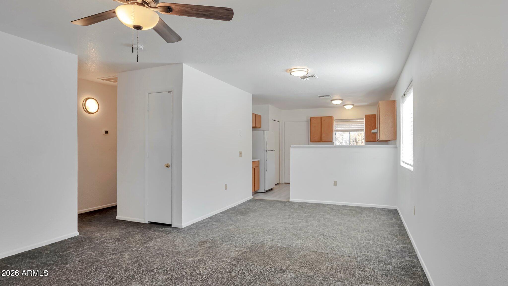 4125 North Pima Way Rimrock, AZ 86335 - Photo 5 of 14 an empty room with chandelier fan and windows