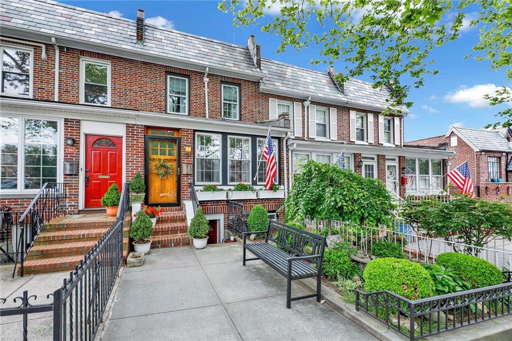 front view of a brick house with a small yard