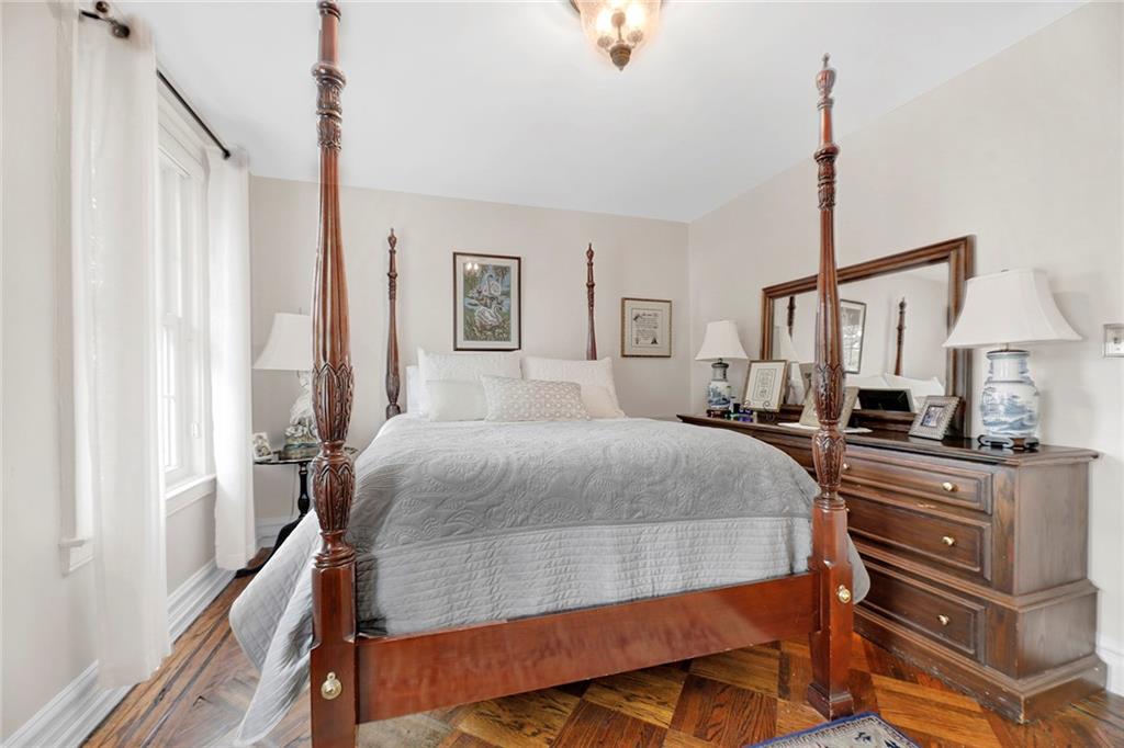 90 MacKay Place Brooklyn, NY 11209 - Photo 17 of 32 a bedroom with a bed and wooden floor
