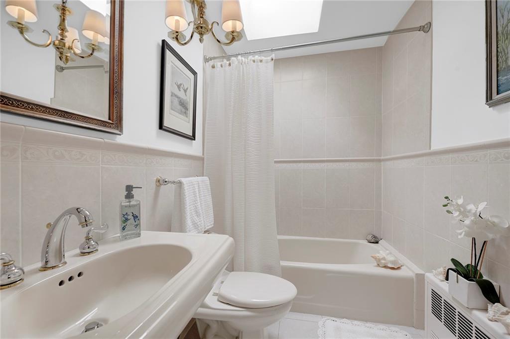 90 MacKay Place Brooklyn, NY 11209 - Photo 19 of 32 a bathroom with a sink a toilet and a bathtub