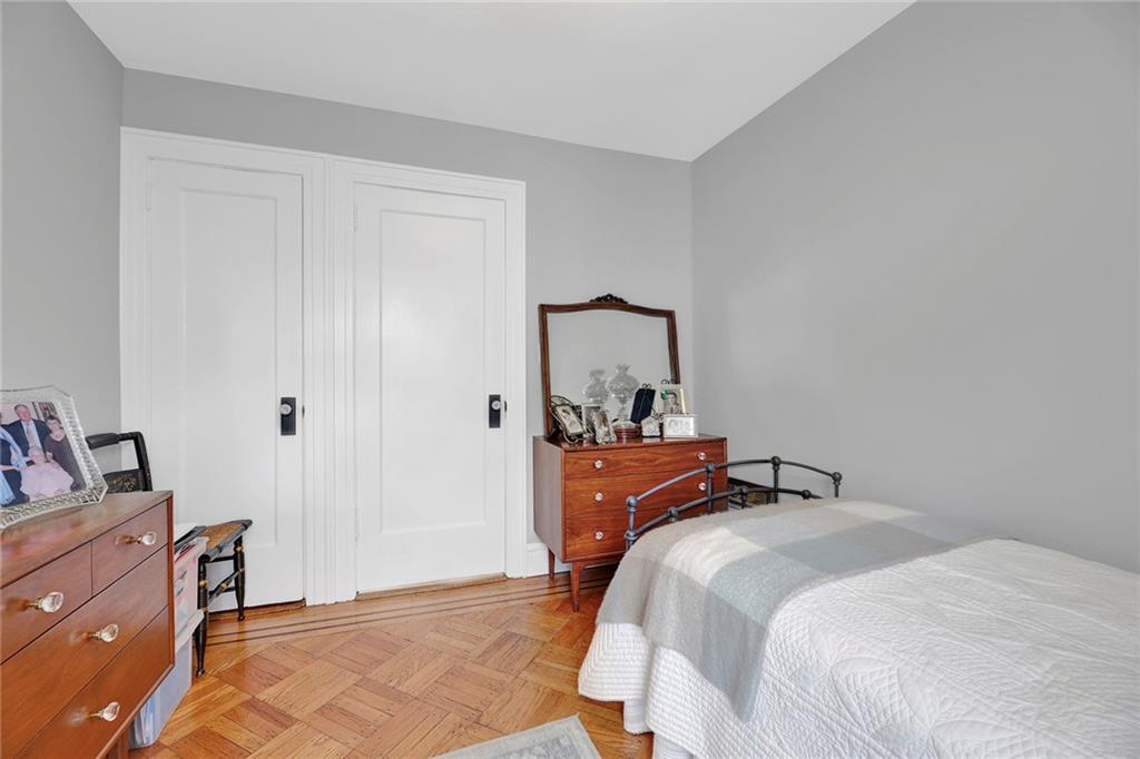 90 MacKay Place Brooklyn, NY 11209 - Photo 24 of 32 a bedroom with a bed and wooden floor