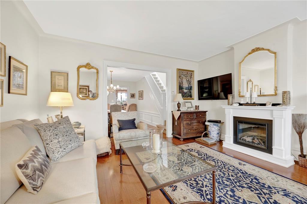 90 MacKay Place Brooklyn, NY 11209 - Photo 4 of 32 a living room with furniture a flat screen tv and a fireplace