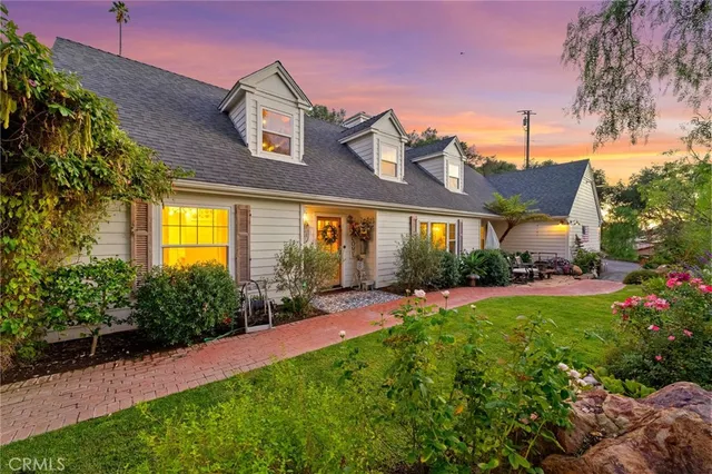 an aerial view of residential houses with outdoor space and trees all around