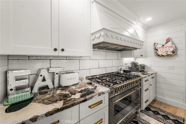 a view of a kitchen counter space a sink appliances and cabinets