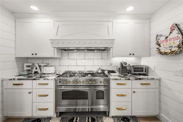 a kitchen with granite countertop a stove and a sink