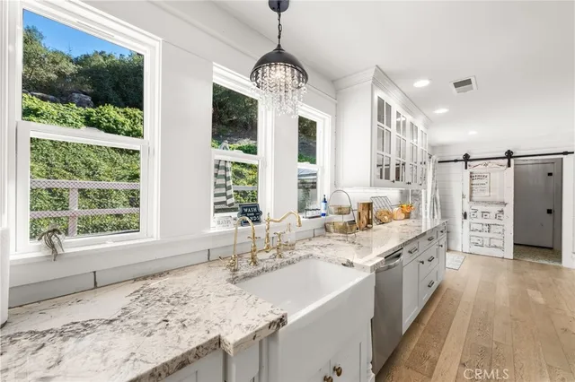 a kitchen with appliances a counter space and cabinets