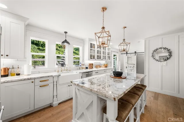 a bedroom with a large bed and a flat tv screen on dresser