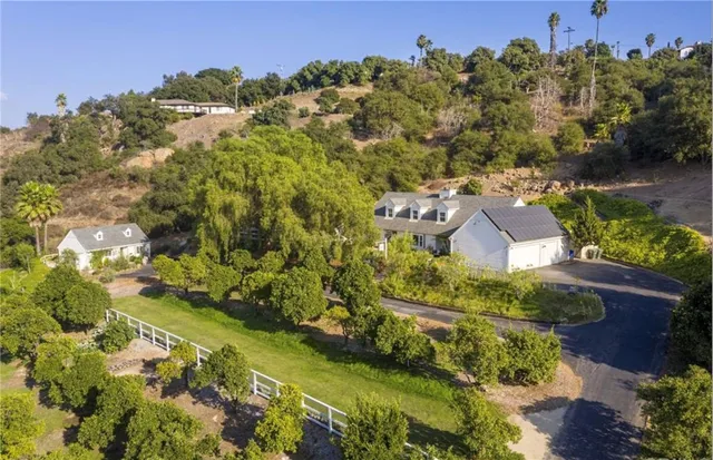 a view of a house with a yard and sitting area