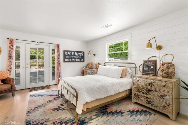 a view of a hallway with wooden floor and entryway