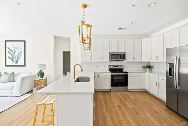 a kitchen with a sink a stove a refrigerator and a microwave