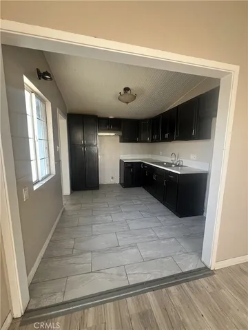a view of kitchen with cabinets and wooden floor