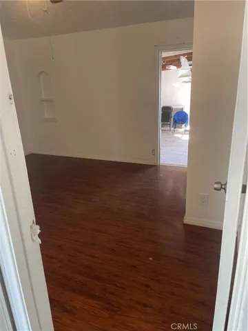 a view of hallway with wooden floor