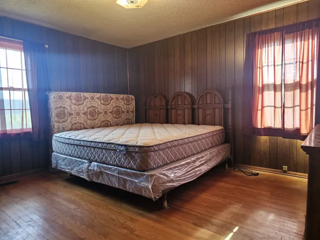 a bedroom with a bed and window