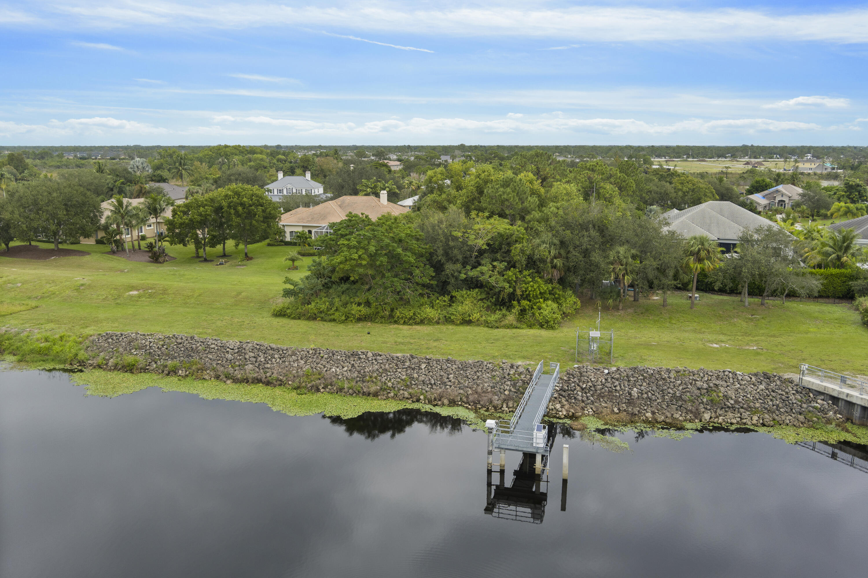 3544 Southwest Rivers End Way Palm City, FL 34990 - Photo 8 of 17 a view of a lake with a building in the background