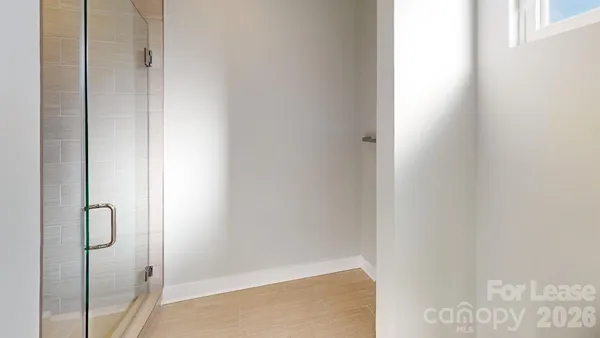 an empty room with windows and closet