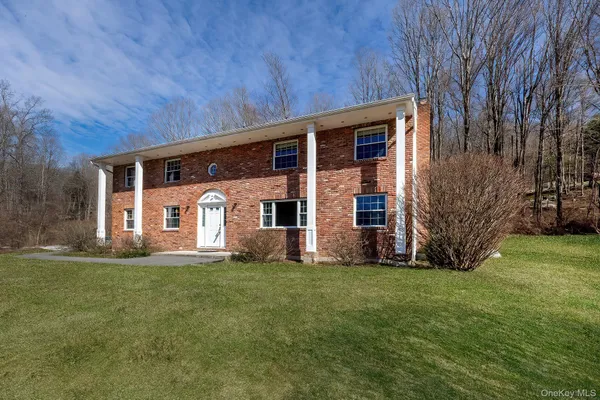 a front view of house with yard and green space