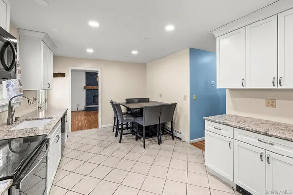 a kitchen with stainless steel appliances kitchen island granite countertop a sink and cabinets
