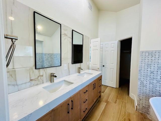 17119 Upper Bay Road Addison, TX 75001 - Photo 13 of 29 a bathroom with a double vanity sink and mirror