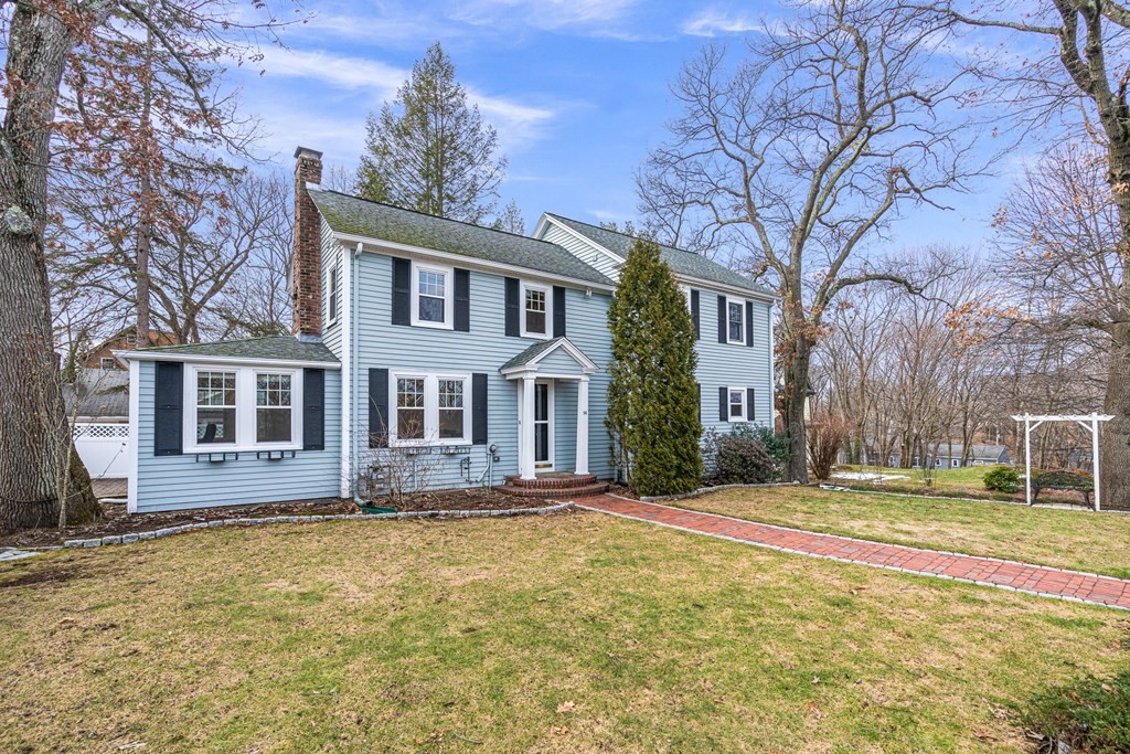 a front view of a house with trees around