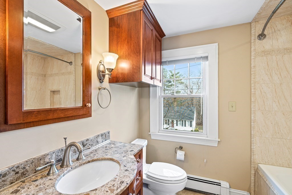 14 Fife Road Wellesley, MA 02481 - Photo 24 of 36 a bathroom with a granite countertop toilet a sink and a mirror