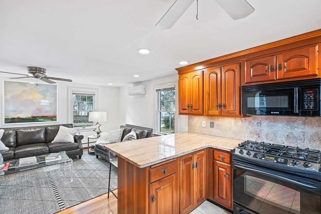 14 Fife Road Wellesley, MA 02481 - Photo 5 of 36 a kitchen with stainless steel appliances granite countertop a stove and a view of living room