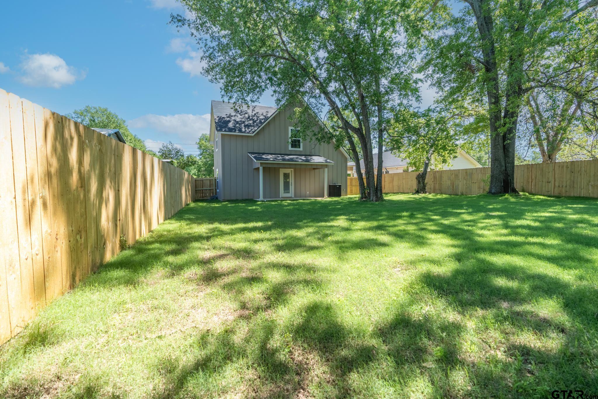 233 Harrison Street Longview, TX 75601 - Photo 37 of 44 a view of a house with a big yard and large tree