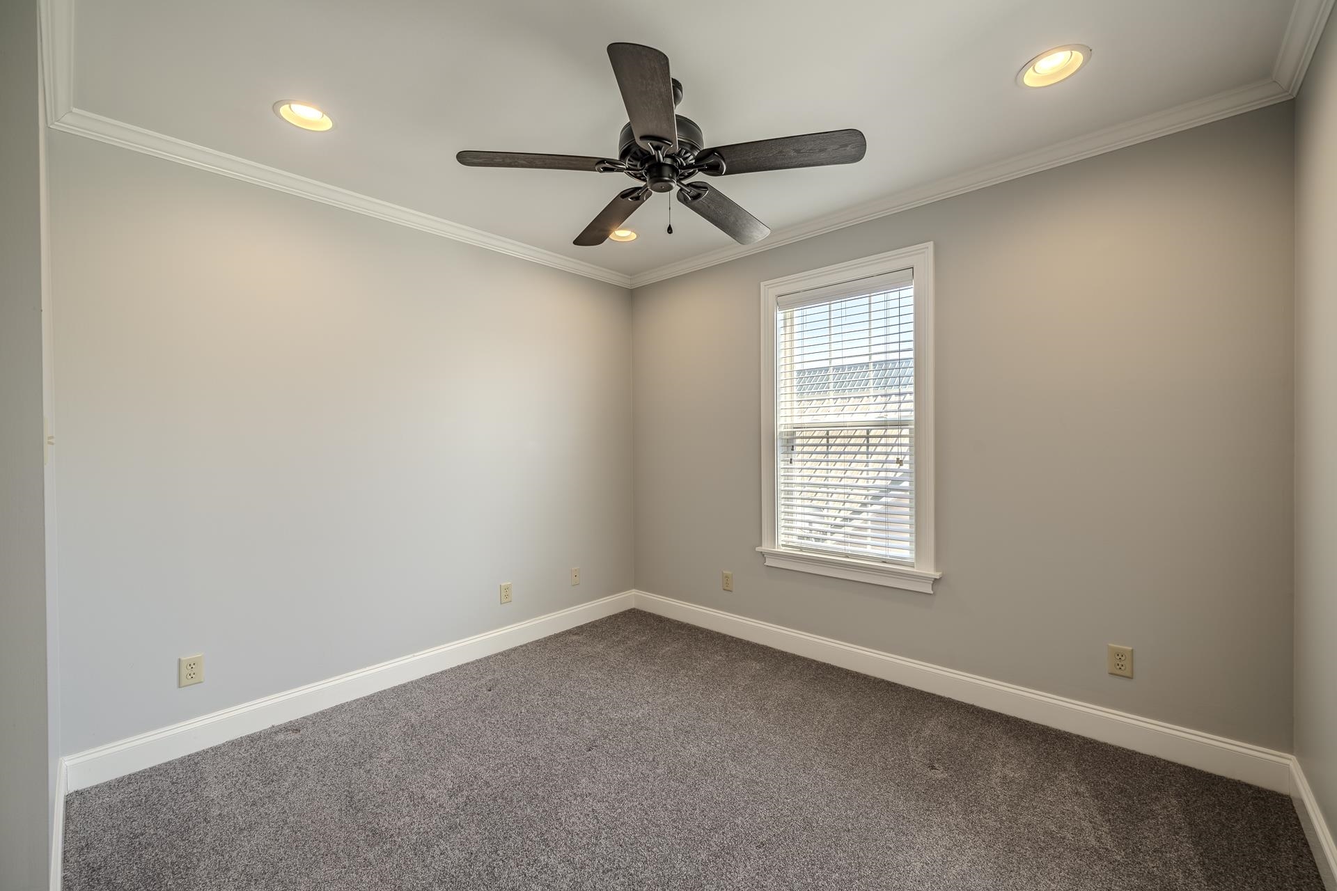 9 Mountain View Iuka, MS 38852 - Photo 19 of 32 Unfurnished room featuring dark carpet, recessed lighting, crown molding, and ceiling fan