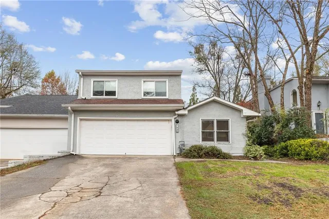 a view of a house with a yard and garage